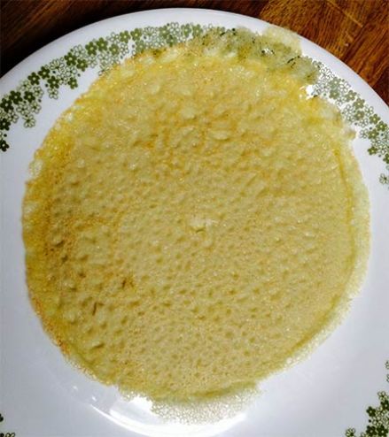 Cooked gluten-free crepe on plate.