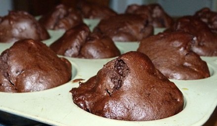 Close up of baked chocolate muffin in muffin pan.