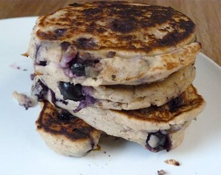 Stack of gluten free blueberry pancakes on a white plate.